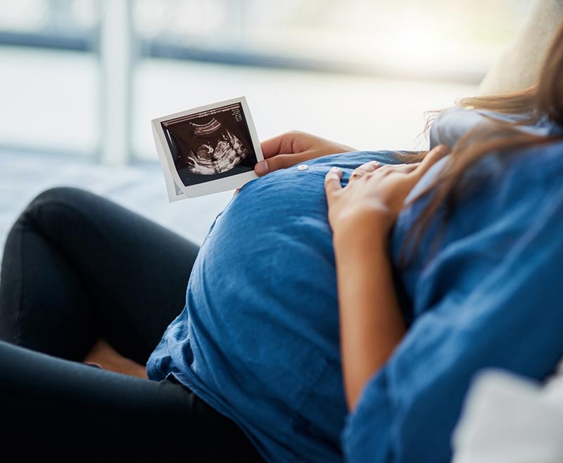 pregnant woman holding scan